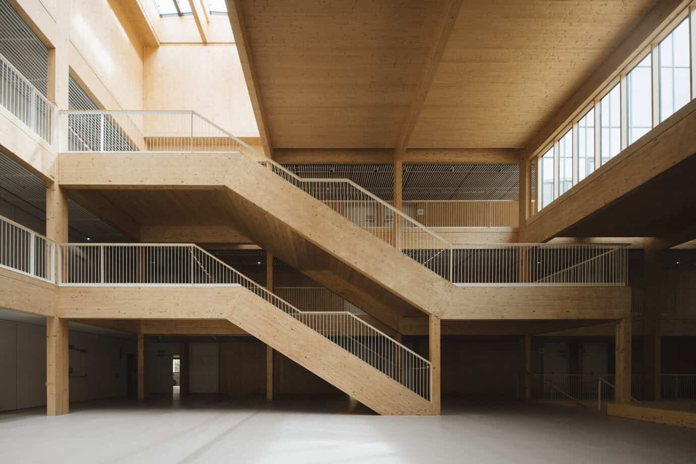 Interior de edificio con estructura CLT de madera laminada cruzada fabricado por Madergia, con escaleras y forjados de madera vista